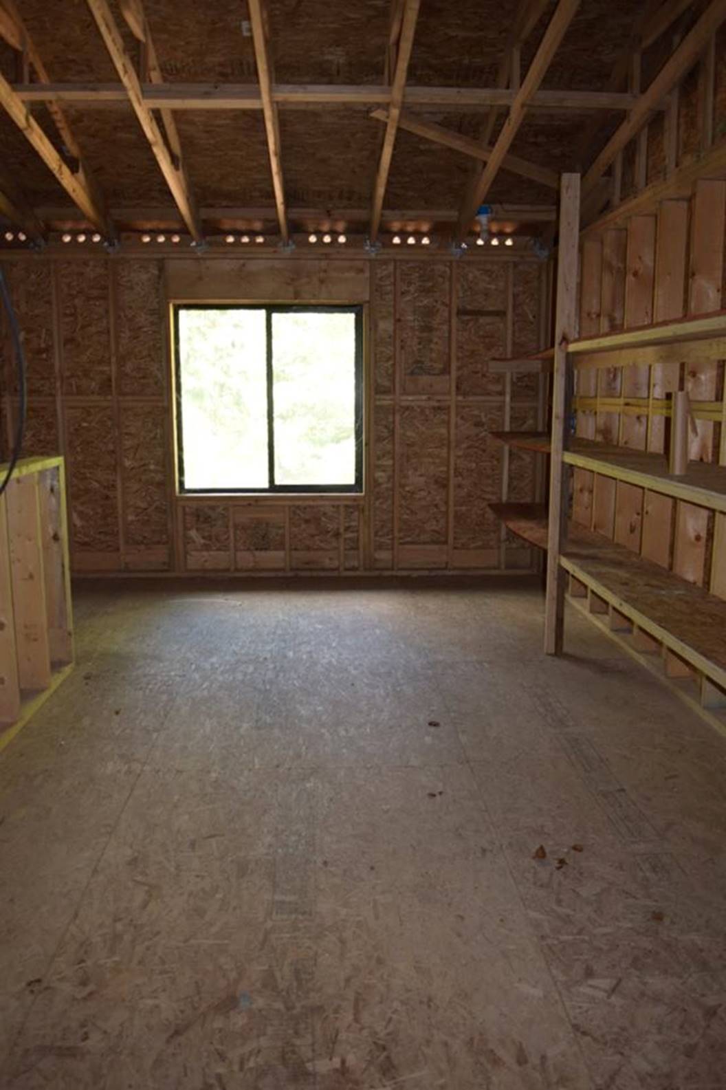 zillow storage room with shelves view to front window