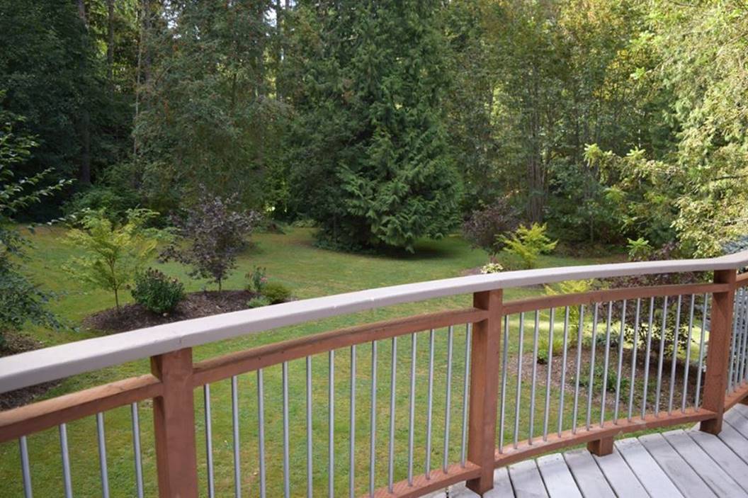 zillow big deck view off curved railing to big side yard and berms